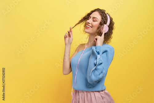 Model listening music with headphones with closed eyes.