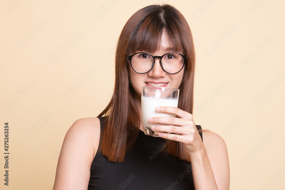 Healthy Asian woman drinking a glass of milk. Healthy Asian woman drinking a glass of milk.