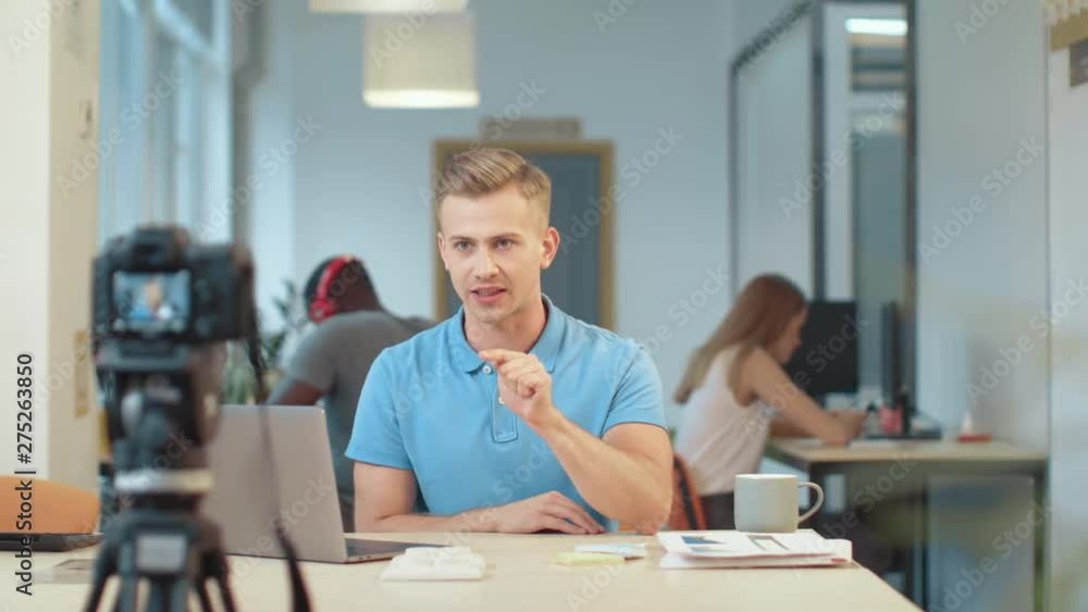 Handsome blogger recording podcast. Portrait of guy sitting in front of camera. Handsome blogger recording podcast. Portrait of guy sitting in front of camera.