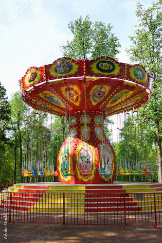 Children's attraction carousel in the summer in the park. Leisure, games for children. Happiness.
