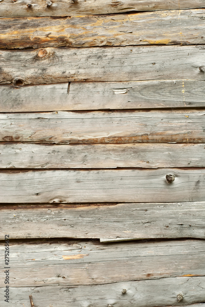Obraz premium Old distorted boards in a row on the wall. Texture of natural rough boards.