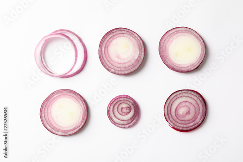 Flat lay composition with red onion rings on white background