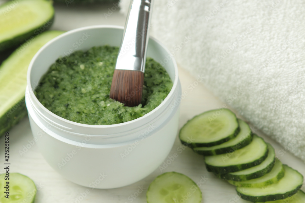 Face mask with cucumber. Cosmetics with cucumber extract on a white wooden table. spa. beauty. Face mask with cucumber. Cosmetics with cucumber extract on a white wooden table. spa. beauty.