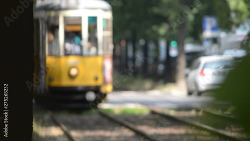 typical Milan tram Arrive through a tree-lined street in the center of Milan