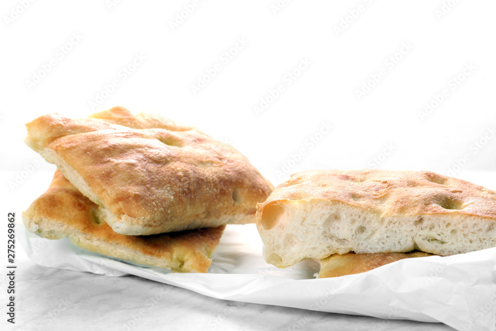 slices of traditional italian focaccia  rest on a marble table with copy space for your text