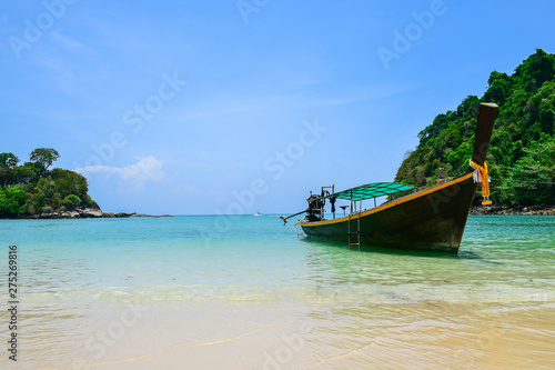 The beauty of the sea, the beach,the blue sky With a long tail boat in the sea of Koh Kam, Laem Son National Park, Ranong Province, Thailand.