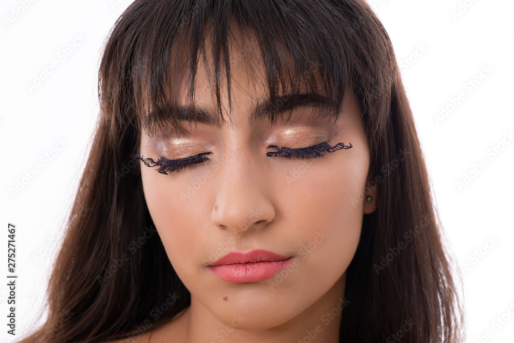 Portrait of Attractive Young Female Model. The girl poses with butterflies as eyelashes in a studio with a white background.