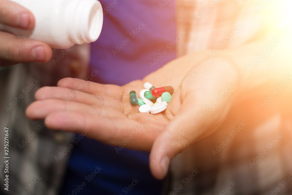Hands with tablets, drinking a pill from a bottle. medicines for a sick person Hands with tablets, drinking a pill from a bottle. medicines for a sick person