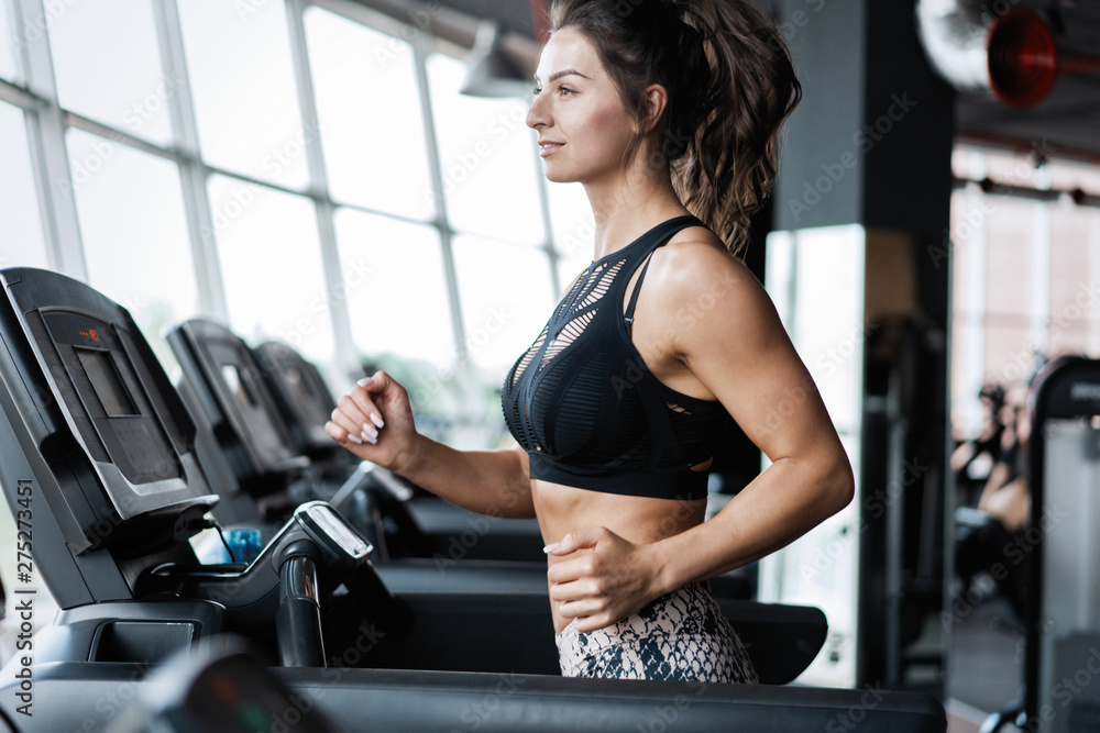 Side view of attractive sports woman on running track. Side view of attractive sports woman on running track.