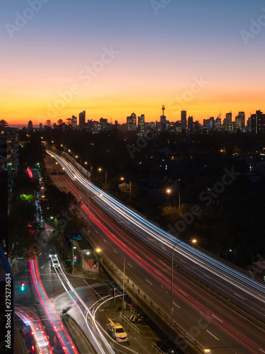 Photography Car trails at dusk with Sydney skyline on the background.
