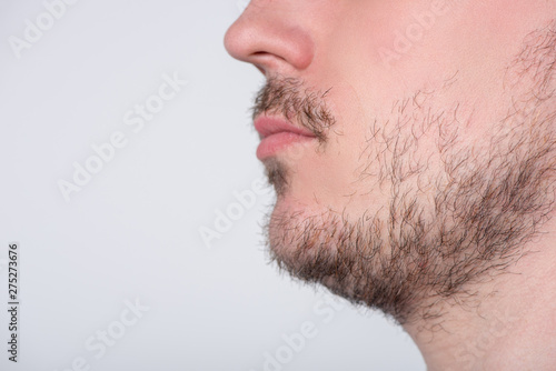 Handsome man with stubble or beard on face close up