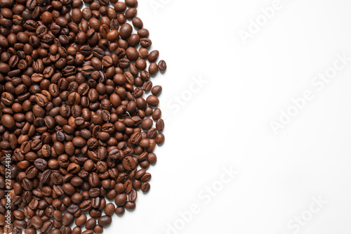 brown coffee grains on a white isolated background with space top view
