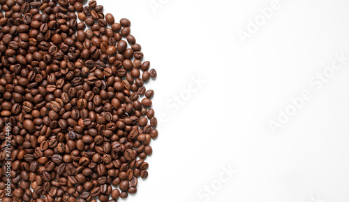 brown coffee grains on a white isolated background with space top view
