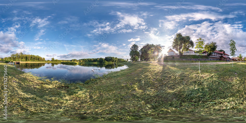 full seamless spherical hdri panorama 360 degrees angle view on grass coast of huge lake or river in summer day with beautiful clouds near the country house in equirectangular projection, VR content