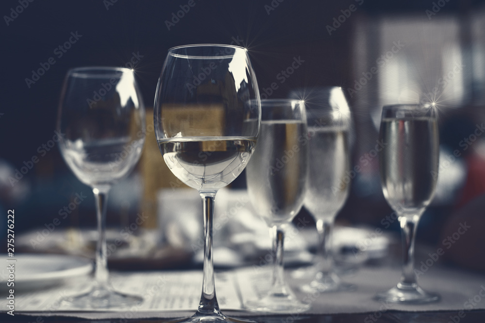 Glasses of white wine on the table in the restaurant Glasses of white wine on the table in the restaurant