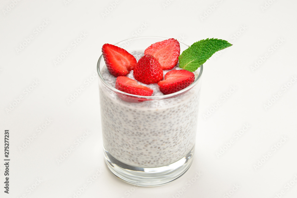 Chia pudding with strawberry and mint on a white background. Space for text or design. Chia pudding with strawberry and mint on a white background. Space for text or design.