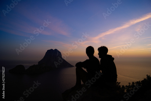 A couple in love watching an amazing sunset in Ibiza,Spain