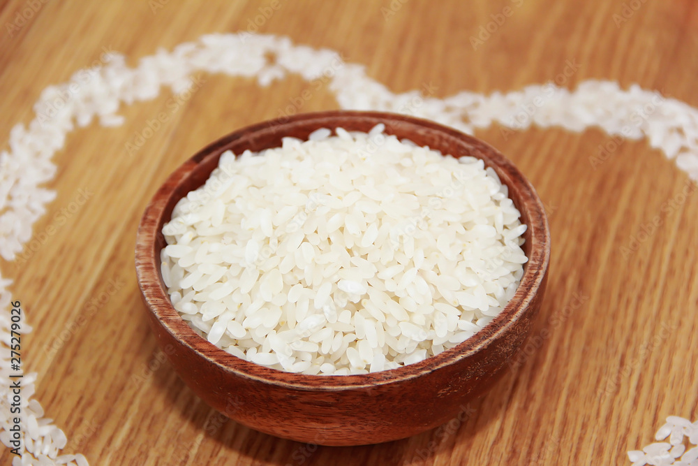 white rice in a wooden plate and rice pattern in the shape of a heart white rice in a wooden plate and rice pattern in the shape of a heart