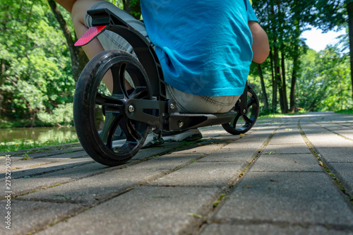 Adult male sitting on a small scooter