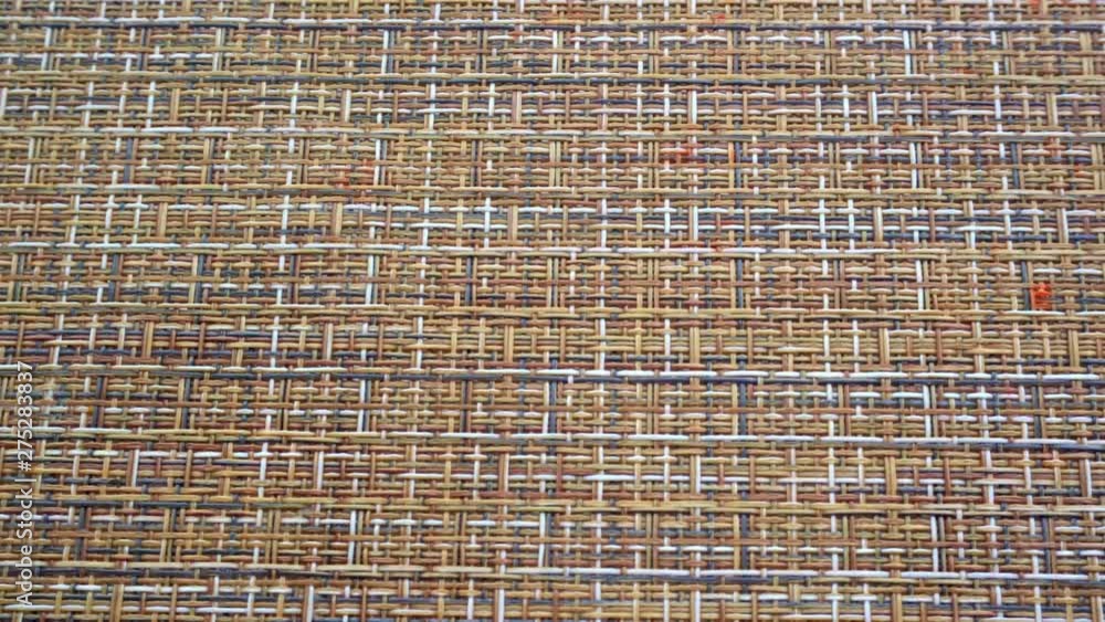 The texture of the fabric. Beige wicker fabric. Close-up. Can be used as a background. The texture of the fabric. Beige wicker fabric. Close-up. Can be used as a background.