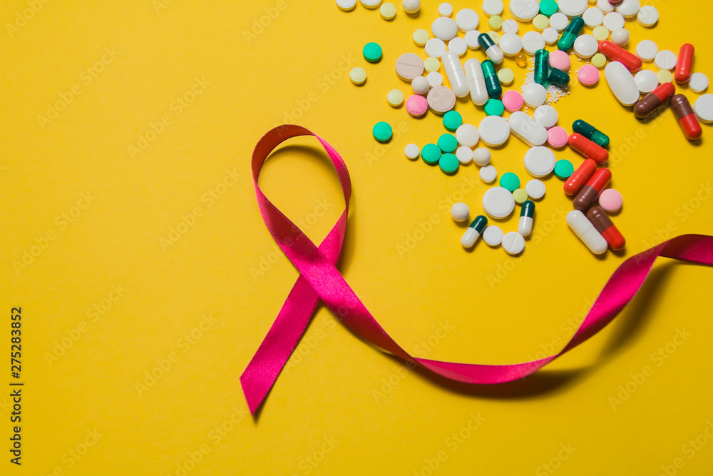 medicines and vitamins. place to insert text. Health. Assortment of pills and capsules isolated on a yellow background. Red ribbon. The concept of World Salvation Day. informing about AIDS medicines and vitamins. place to insert text. Health. Assortment of pills and capsules isolated on a yellow background. Red ribbon. The concept of World Salvation Day. informing about AIDS