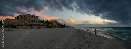 Photography Beautiful panoramic view of vacation resort on the sandy beach during a dramatic cloudy sunset