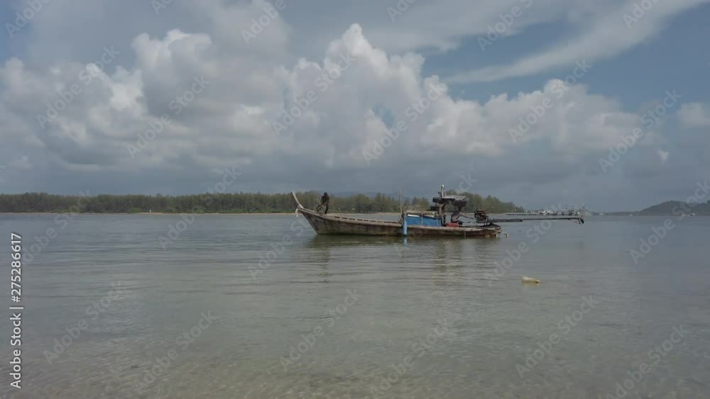 Wide angle hand held shot of a large fishing boat moving through shallow waters, just off the beach. Wide angle hand held shot of a large fishing boat moving through shallow waters, just off the beach.