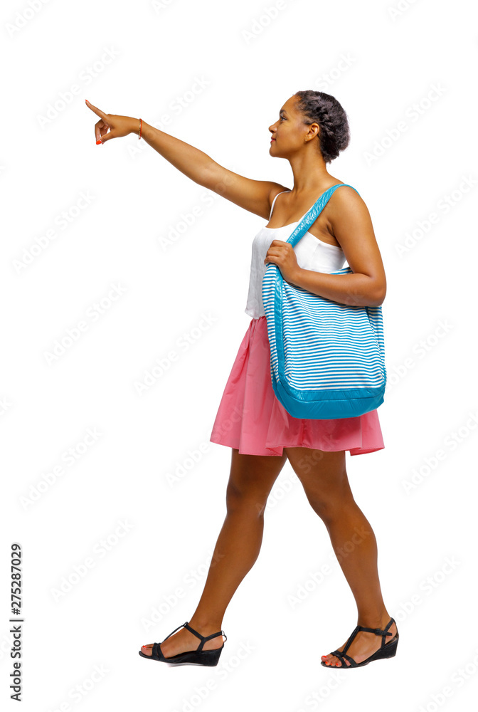 Side view of pointing African-American with a beach bag that goes to the side. Side view of pointing African-American with a beach bag that goes to the side.
