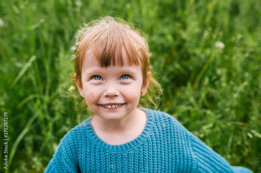 Outdoors portrait of cute little girl in summer day
