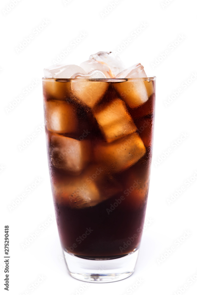 Cola in a glass with dancing bubbles on ice cubes isolated on white background Cola in a glass with dancing bubbles on ice cubes isolated on white background