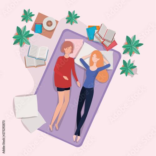 young women relaxing in mattress in the bedroom