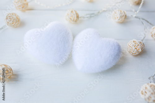 White hearts on wooden background. Saint Valentine's day concept. Love and romantic photo. Postcard for holiday. Small rustic lights.