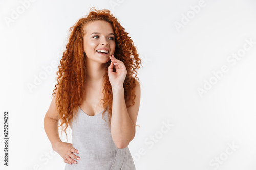 Fototapeta Portrait of an attractive woman with long curly red hair