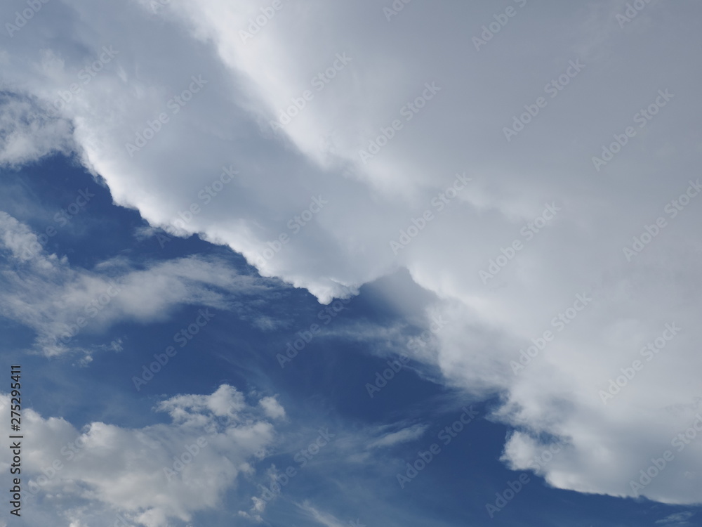 Fototapeta premium Cloudy sky background, view of fat dark clouds moving in soft rain with blue sky background.
