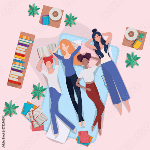 interracial women relaxing in mattress in the bedroom