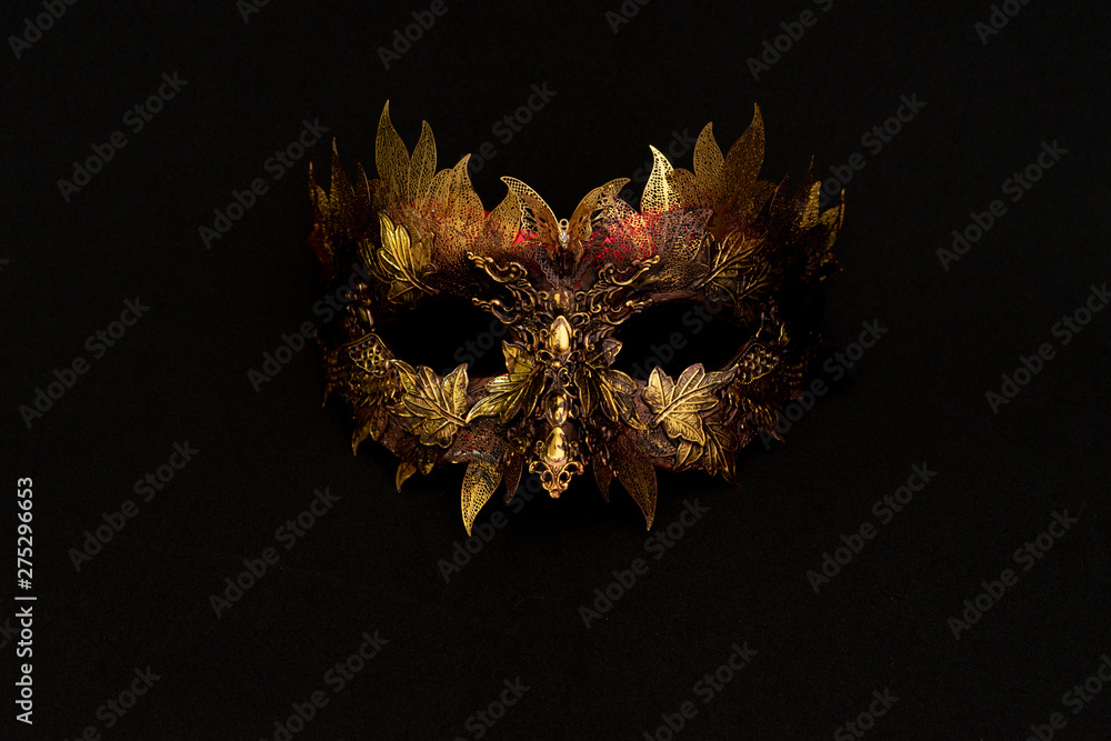Venetian mask in gold and red with metallic pieces in the form of leaves. original and unique design, handmade crafts - obrazy, fototapety, plakaty 