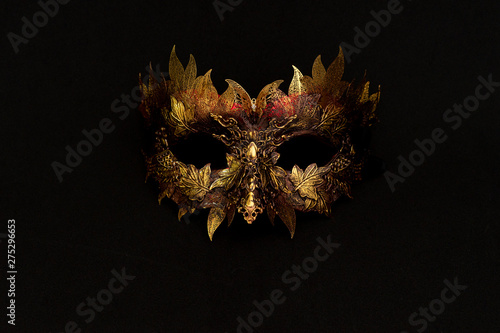 Obraz na plátně Venetian mask in gold and red with metallic pieces in the form of leaves