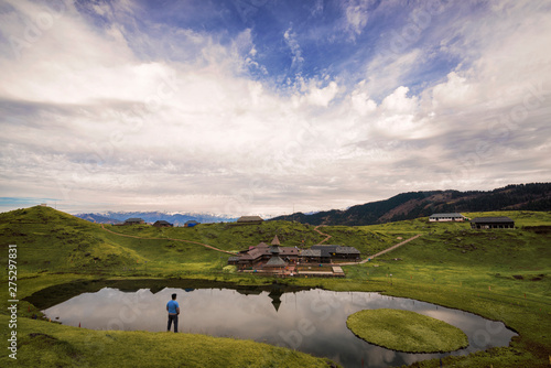 Man enjoying the view of the mysterious Prashar lake photo