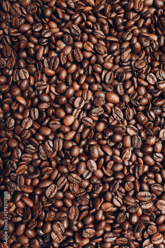 Roasted coffee beans brown seeds texture background wallpaper. © primipil