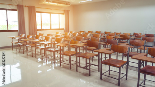 Empty university classroom with wooden chairs and desks. Modern university lecture room without student. Empty university classroom