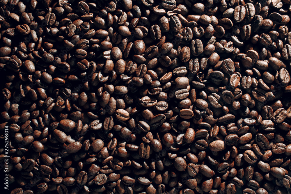 Obraz premium Roasted coffee beans brown seeds texture background wallpaper.
