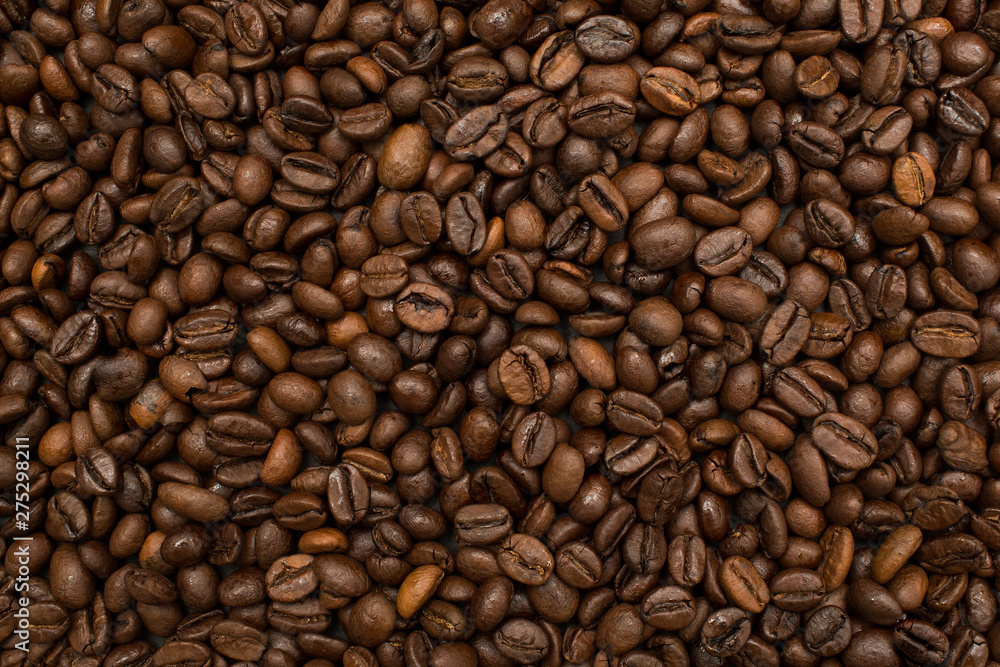 Roasted coffee beans brown seeds texture background wallpaper. Top view. Roasted coffee beans brown seeds texture background wallpaper. Top view.