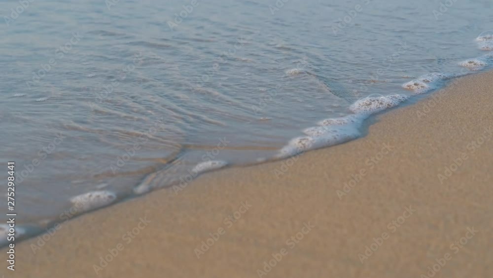 Sea wave rolls on the sand. Calm sea waves on the sand. Sea wave rolls on the sand. Calm sea waves on the sand.