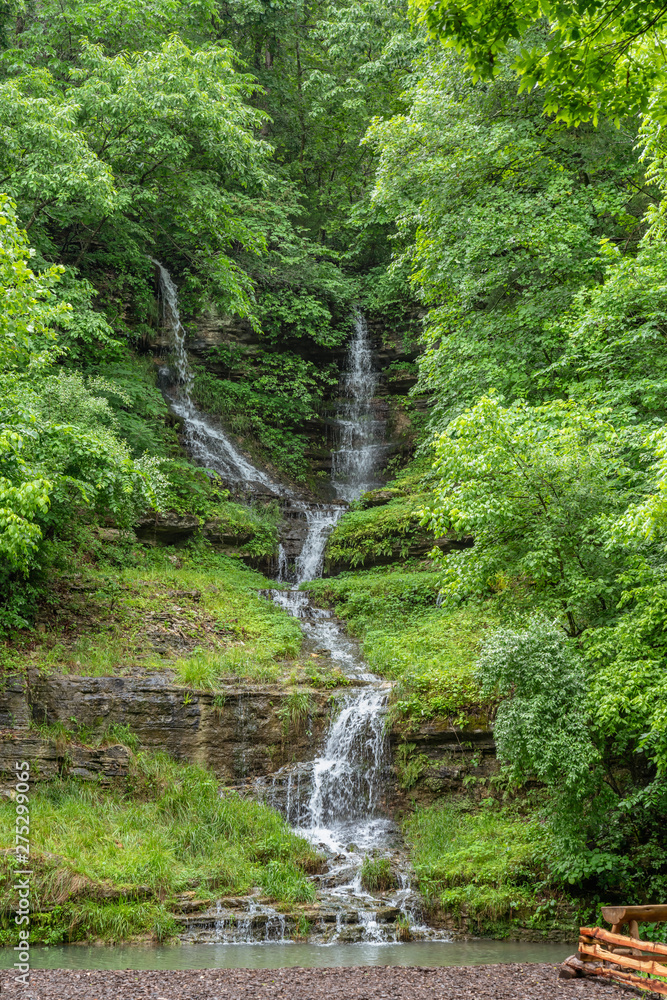 Dual waterfall down canyon wall joining at the base Dual waterfall down canyon wall joining at the base