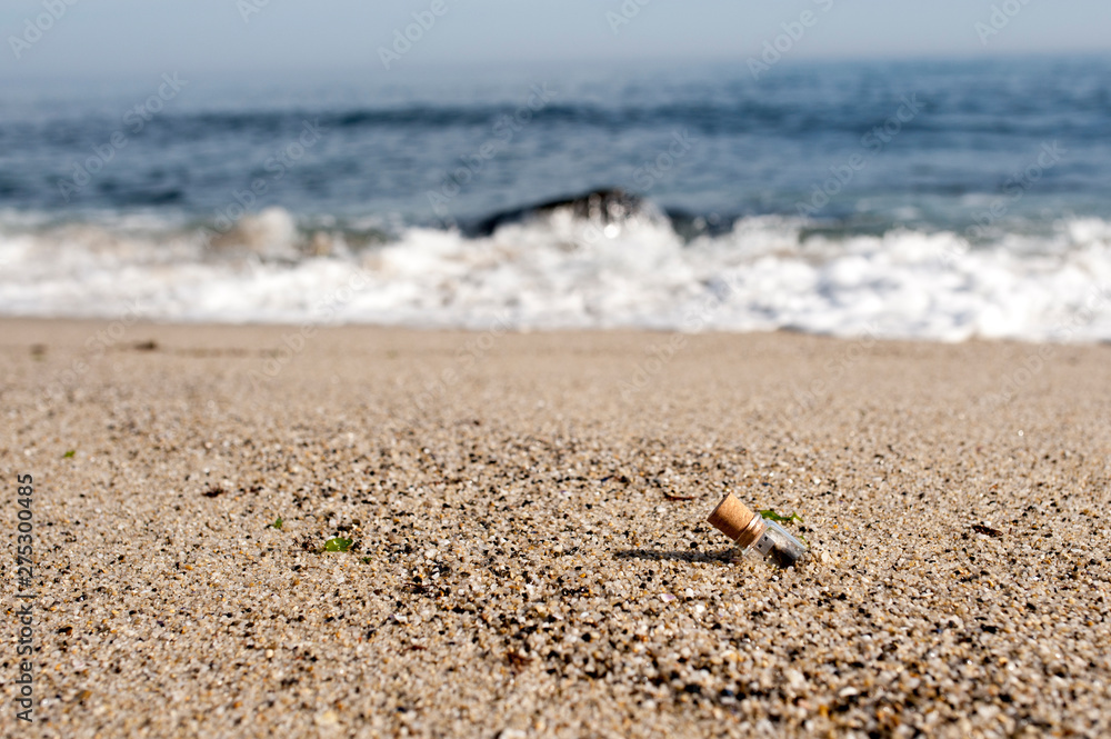 Digital message in a bottle in sand on the beach Digital message in a bottle in sand on the beach