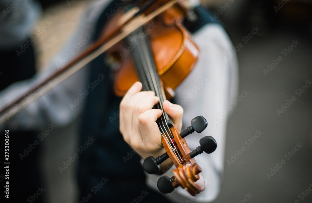 Art and artist. Young elegant man violinist violinist playing violin on black. Classical music. little boy musical instrument Art and artist. Young elegant man violinist violinist playing violin on black. Classical music. little boy musical instrument