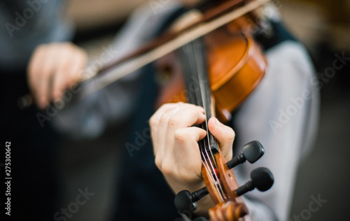 Art and artist. Young elegant man violinist violinist playing violin on black. Classical music. little boy musical instrument