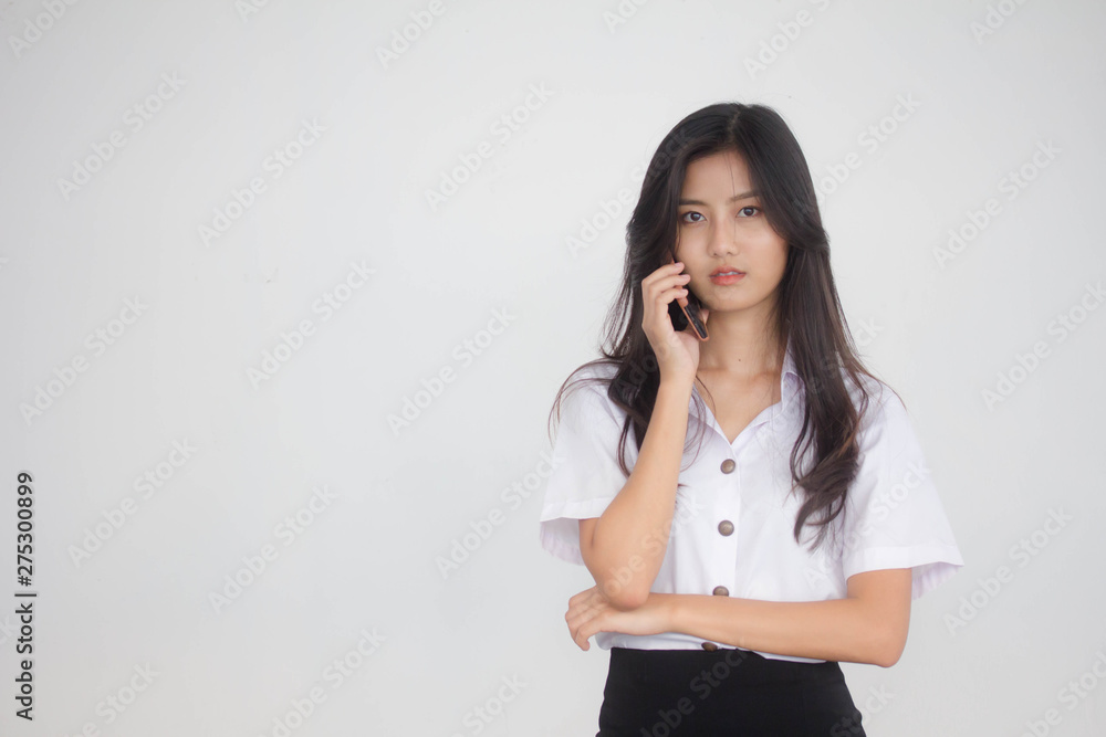 Portrait of thai adult student university uniform beautiful girl calling smart phone Portrait of thai adult student university uniform beautiful girl calling smart phone