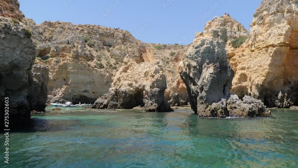 Beautiful seascape of Algarve with its rock formations on a sunny day seen from a motorboat ride. Portugal. Panoramic plane Beautiful seascape of Algarve with its rock formations on a sunny day seen from a motorboat ride. Portugal. Panoramic plane