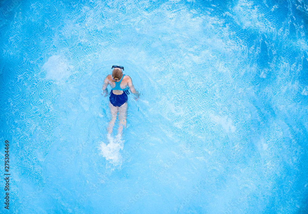 Aerial view of kid in water and summer time 